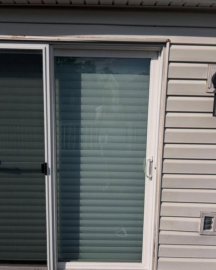 Clean sliding glass door — wipe the grime overlay away to reveal it